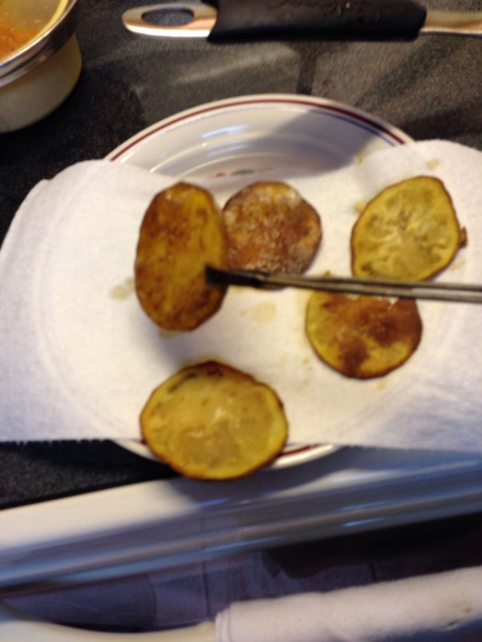 Drain on paper towel 30 seconds, then move to rack in warm oven. The key is to keep them warm and crisp so don't just pile them here or they'll get soggy.