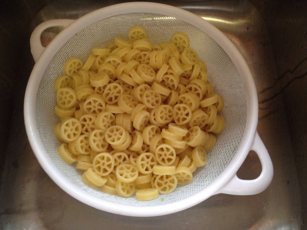 Drain pasta in colander, reserving about a cup of pasta water. Look how cute those wagon wheels are!
