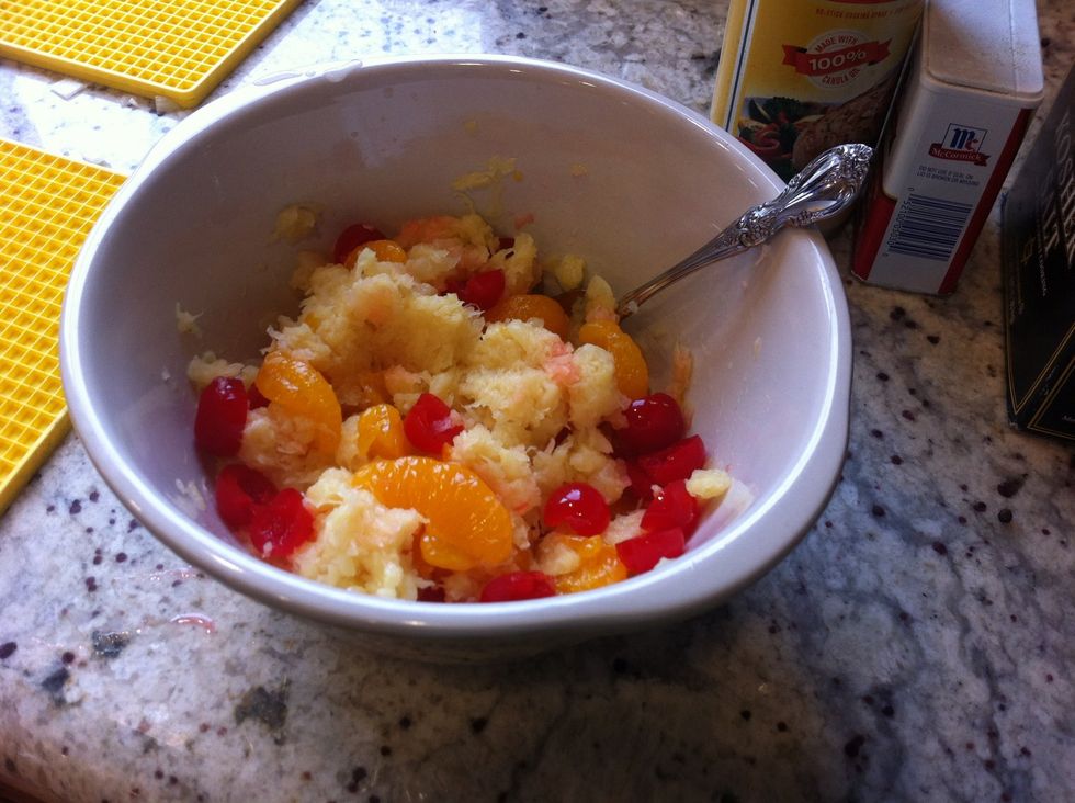 Drain pineapple and oranges. Mix all fruit together.