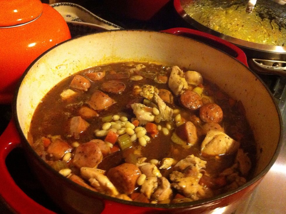 Drain the beans and add to pot with vegetables. Also add meat back in. Add 3 1/2 cups water and bring to a boil. Cover lid and place in preheated oven. Bake for 2 hours.