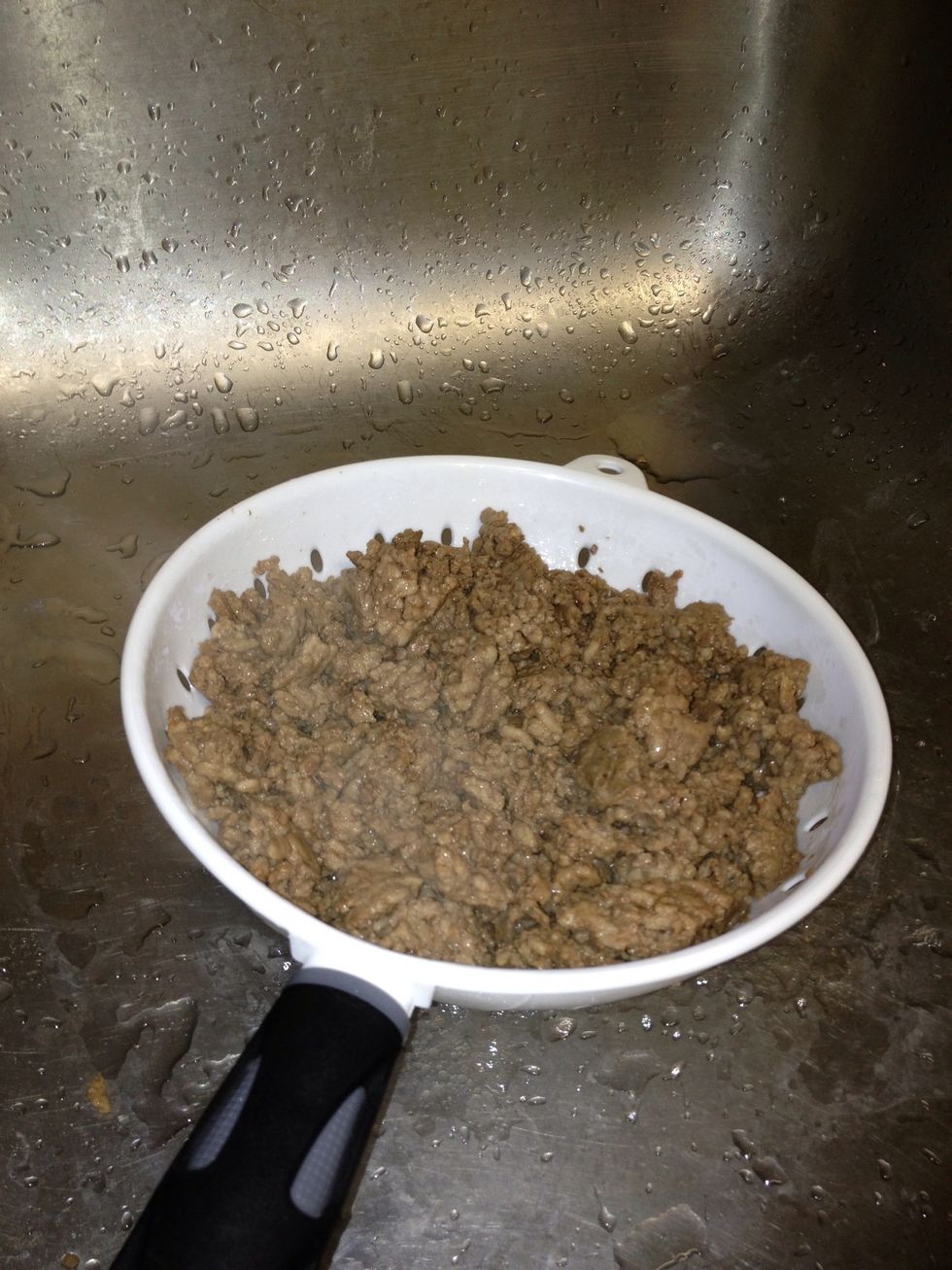 Drain the grease from the meat using a strainer.