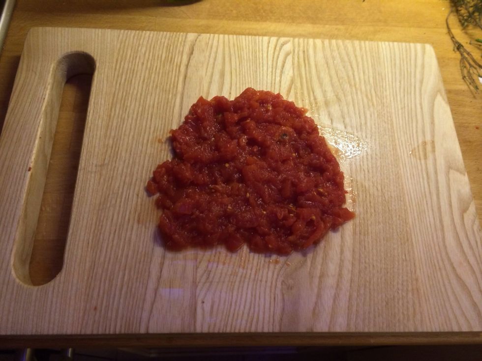 Drain the liquid and pour it in to the pan with the onions, then chop the tomatoes finely and add to the pan as well.