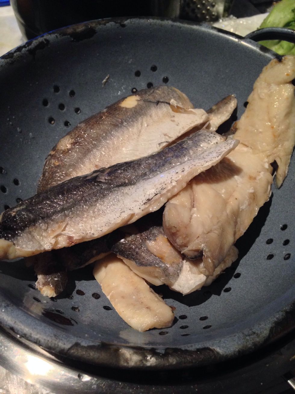 Drain the liquid off the fish and rub the skin off with your fingers. Break up the flesh into chunks and check for bones.