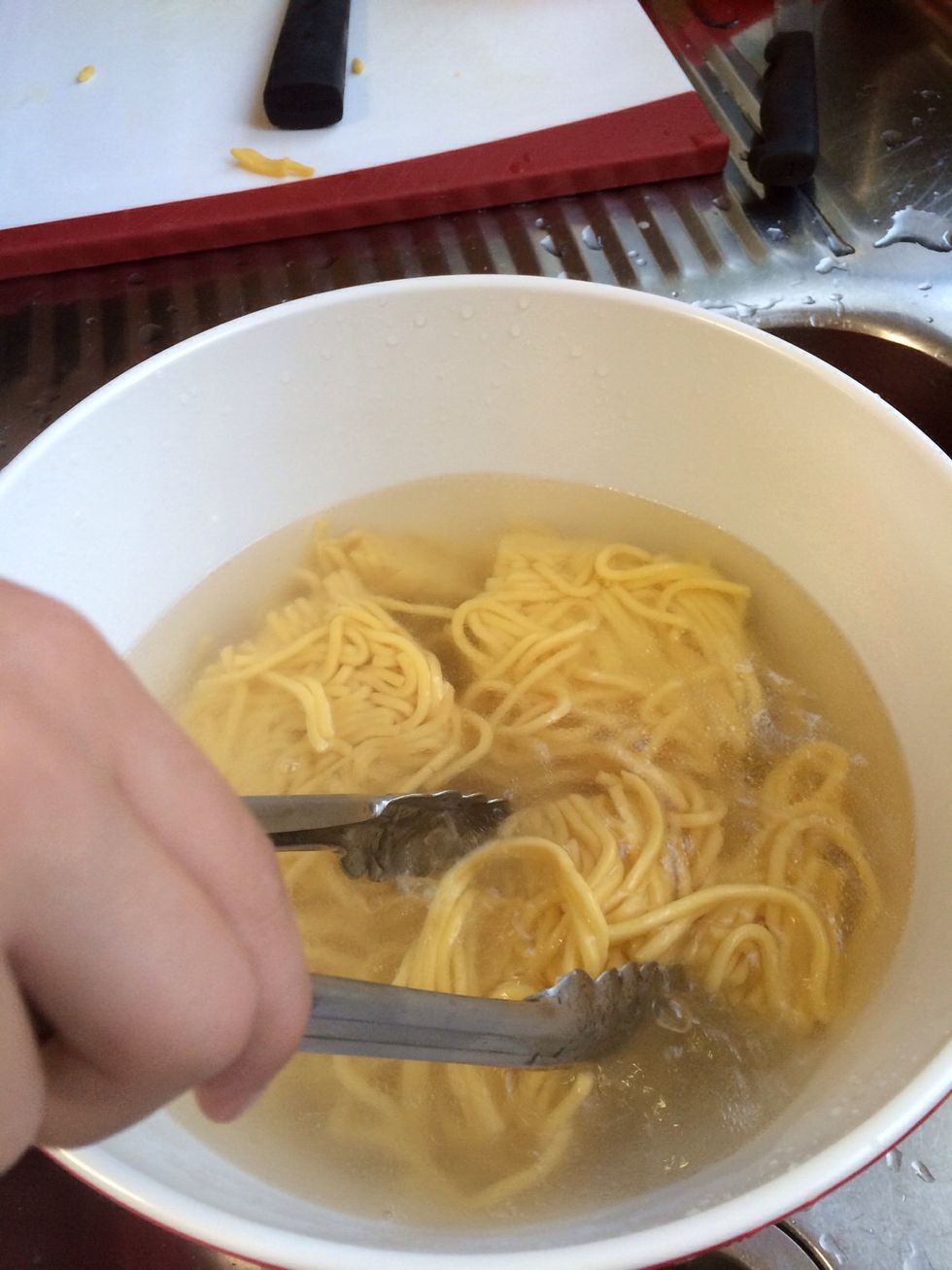 Drain the noodles once they are hot right through.