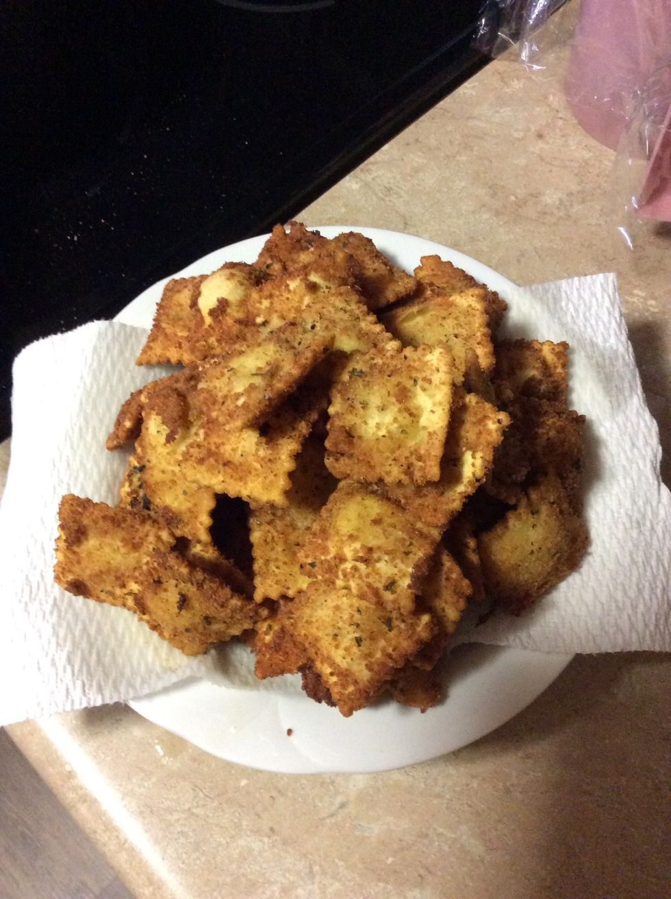 Drain the oil of the raviolis on to paper towels