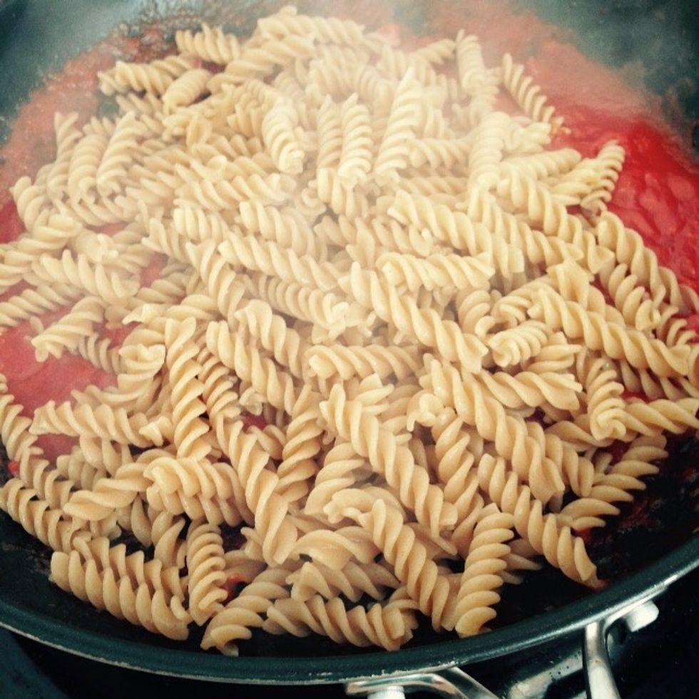 Drain the pasta and add it to the sauce. I am using wholegrain fusilli, but you can chose any other short cut shape you like. Saut\u00e9 quickly to mix sauce and pasta