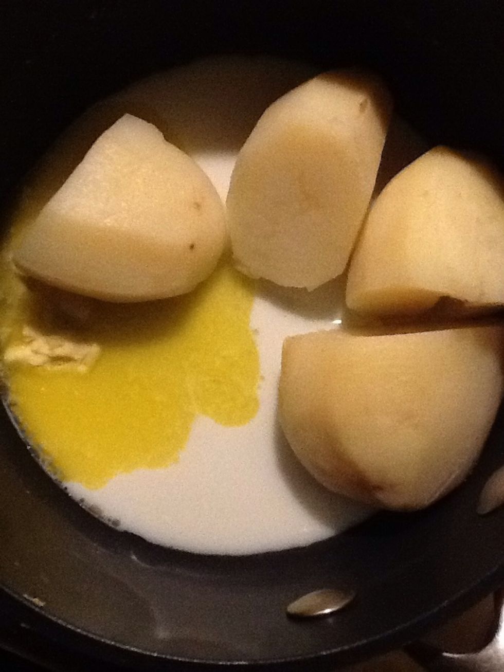 Drain the potatoes and add a little butter and milk.