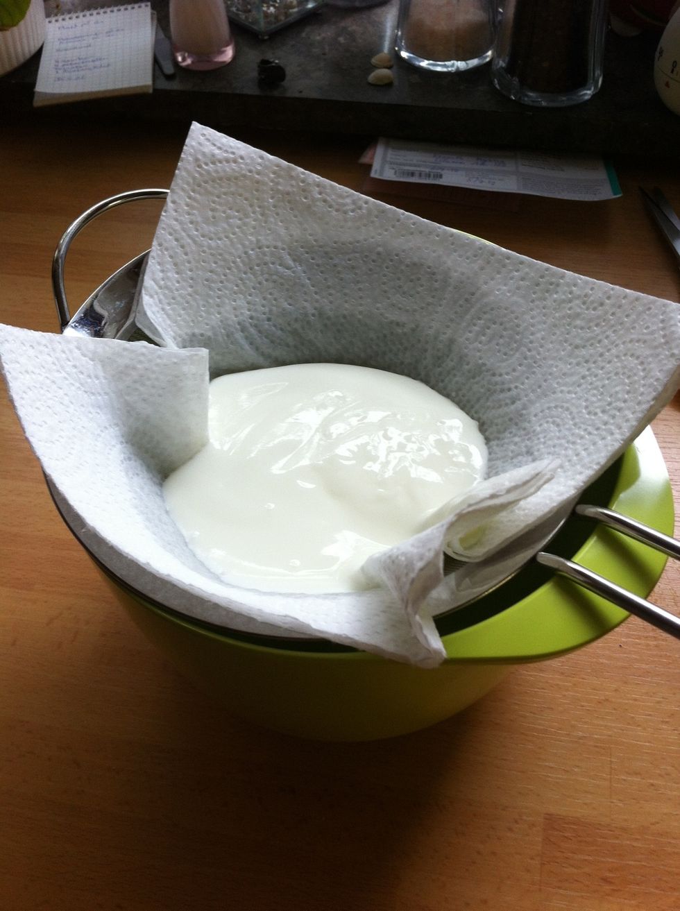 Drain the yogurt by pouring it into a strainer lined with paper towel. Put it in the fridge for about an hour.