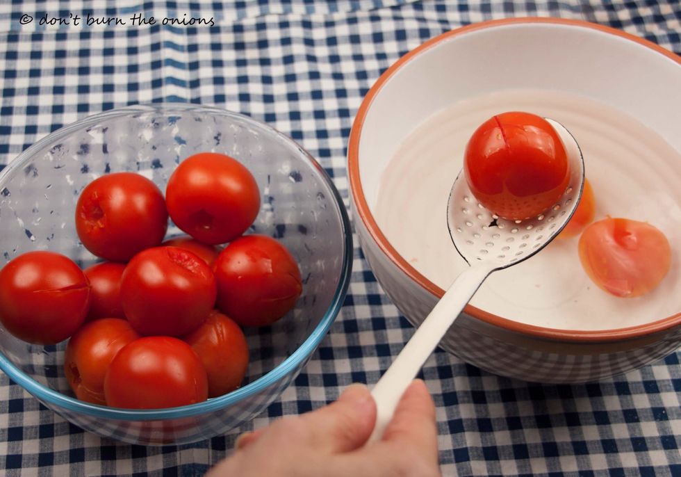Drain tomatoes and transfer them to a clean bowl.