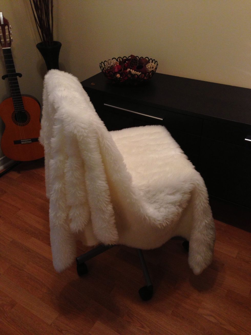 Drape fun fur over the chair. You want to get the most length to wrap right round the chair.