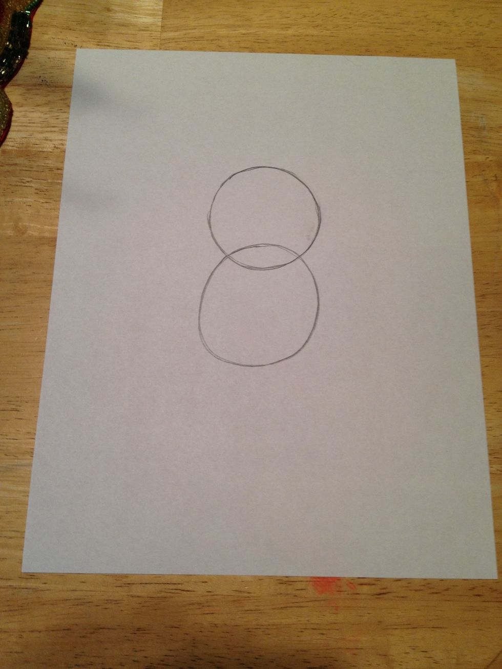 Draw 2 circles. one for the head and 1 for the body.