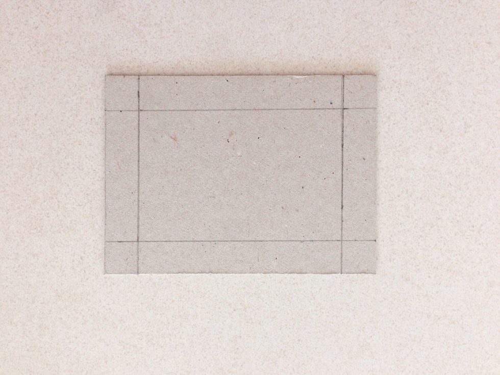 Draw a 0.5" border around on one of the chipboard pieces as shown...