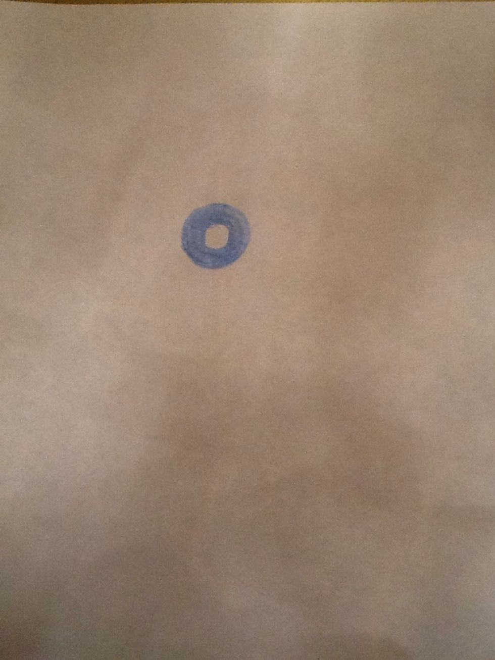 Draw a circle and colour it but leave another circle white inside it.