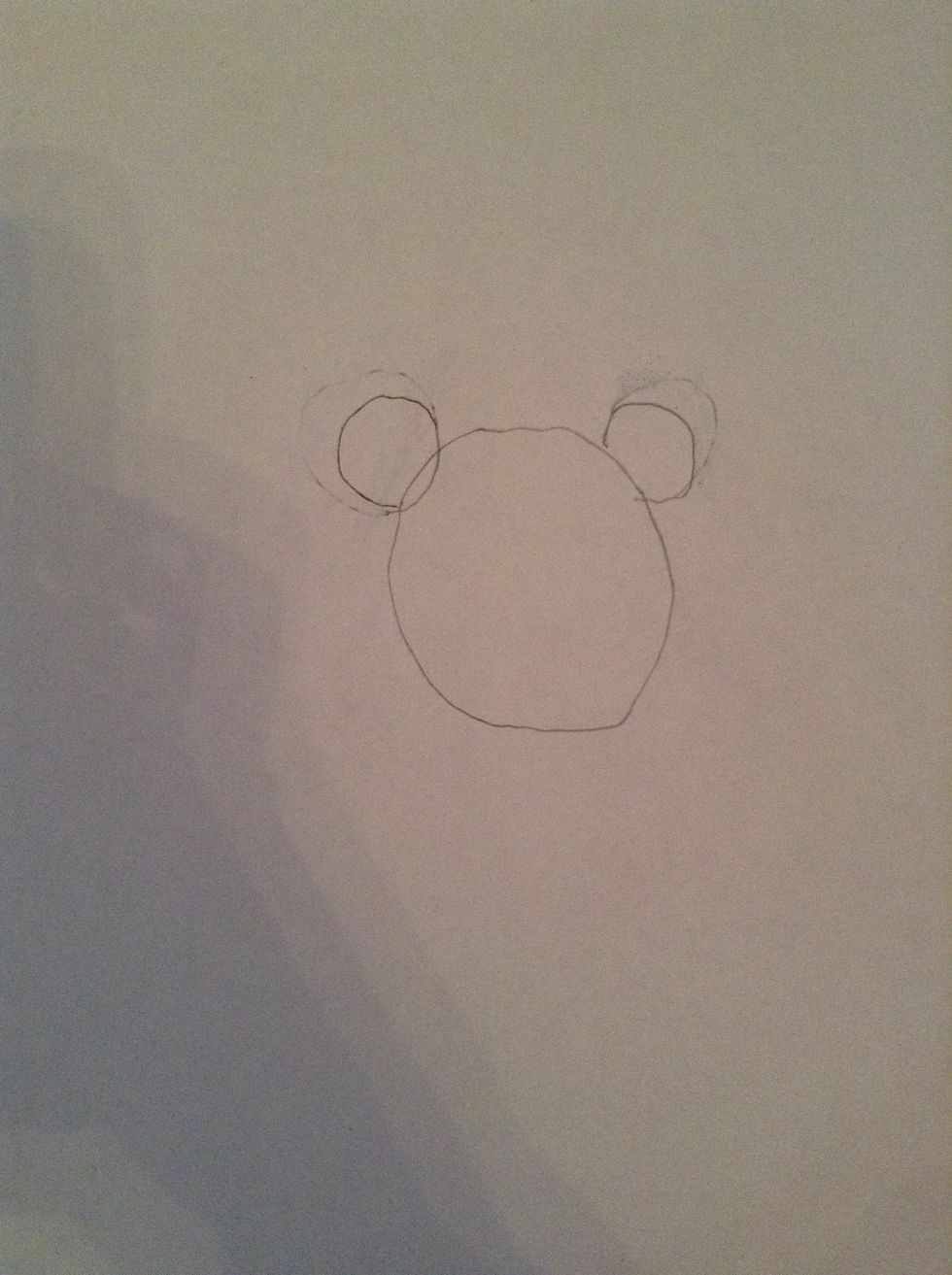 Draw a circle and then draw 2 circles on top of it.