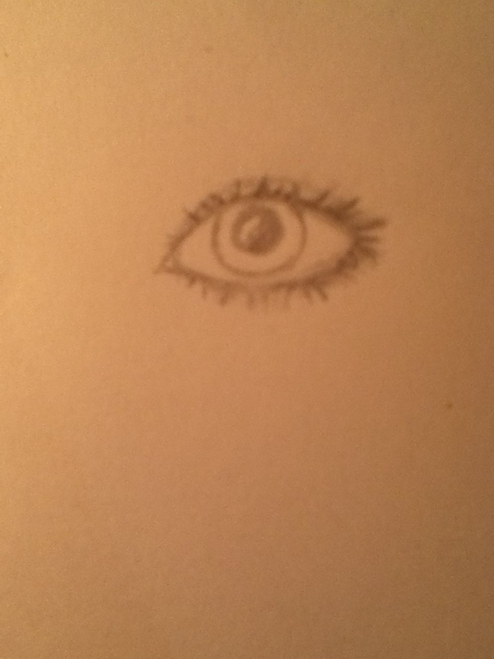 Draw a circle for the inner eye and another circle for the pupil. Leave a white part in the pupil to show where the light hits the eye.