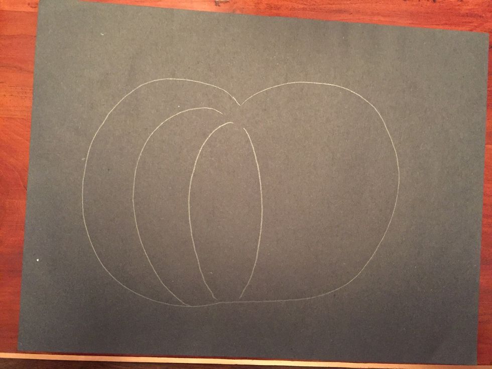 Draw a curved line on the right side of your pumpkin. This line should curve the other way.