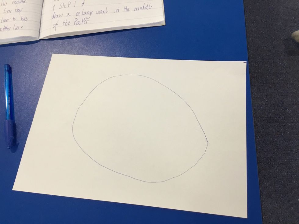 Draw a large oval in the middle of the paper