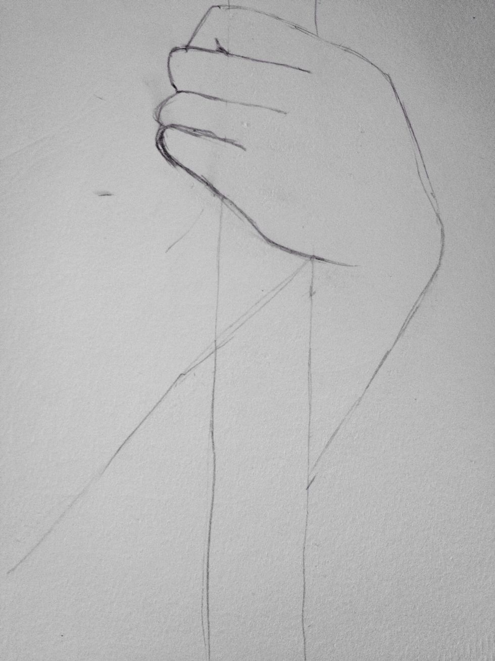 Draw a light straight line from where the bottom of the hand meets the staff in an almost parallel line to the other side of the arm. Like this.
