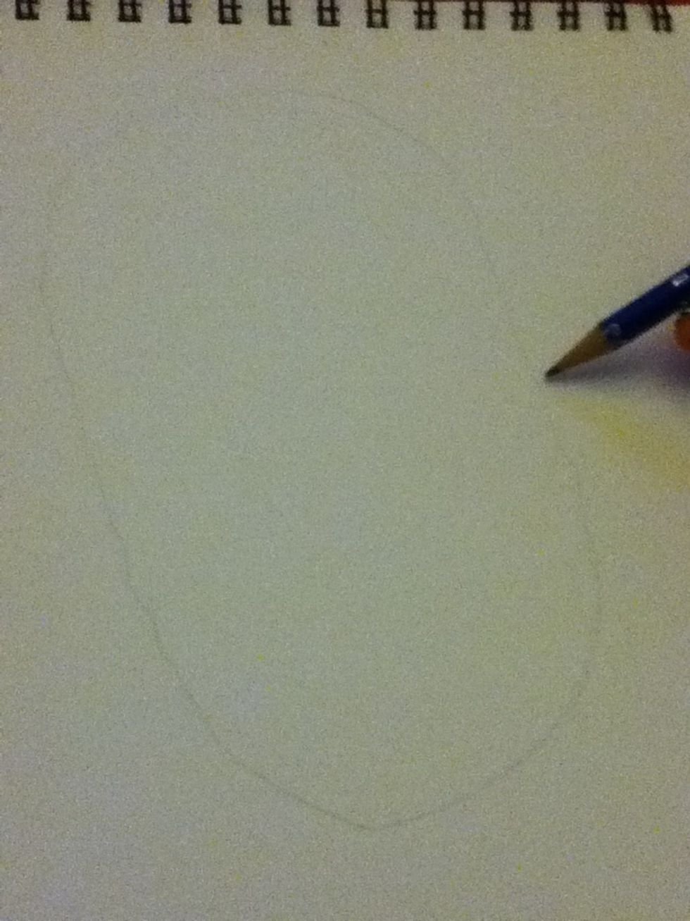 Draw a long oval lightly in pencil