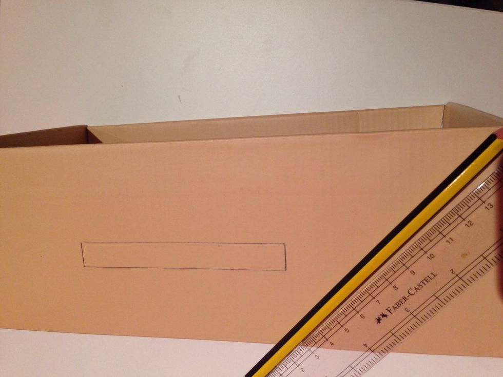 Draw a rectangle on the box with a pencil
