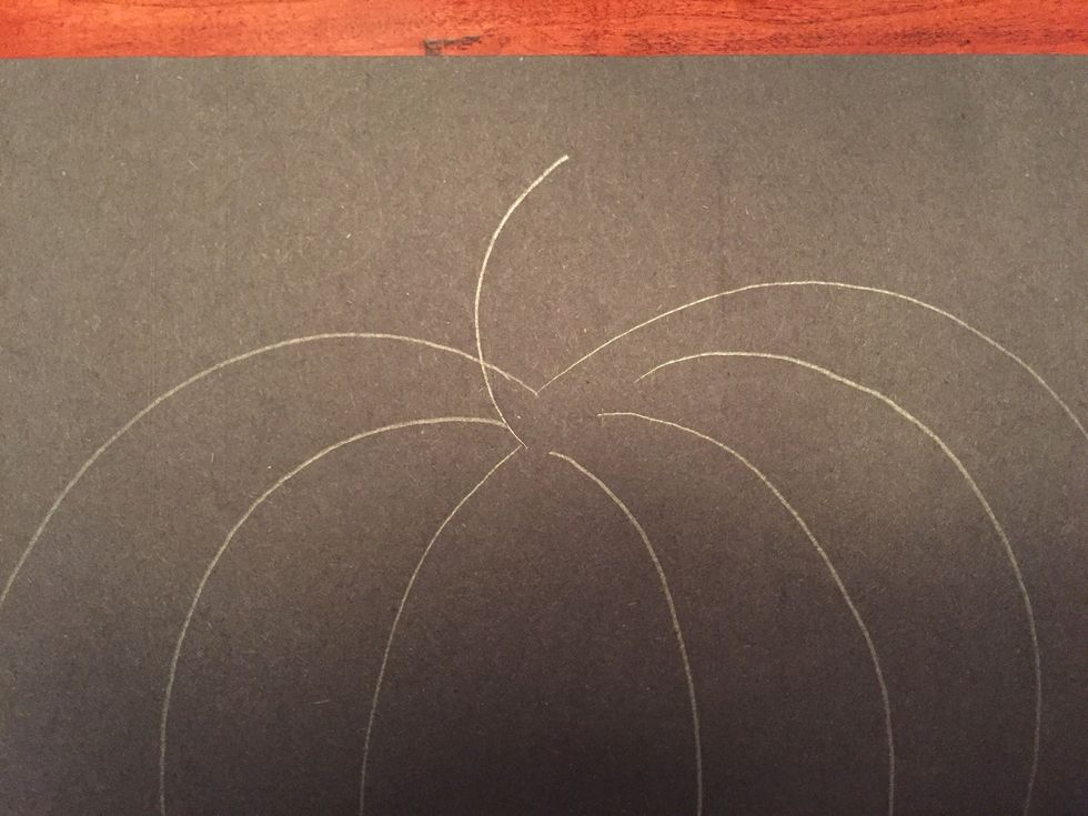 Draw a small curved line at the top of your pumpkin.