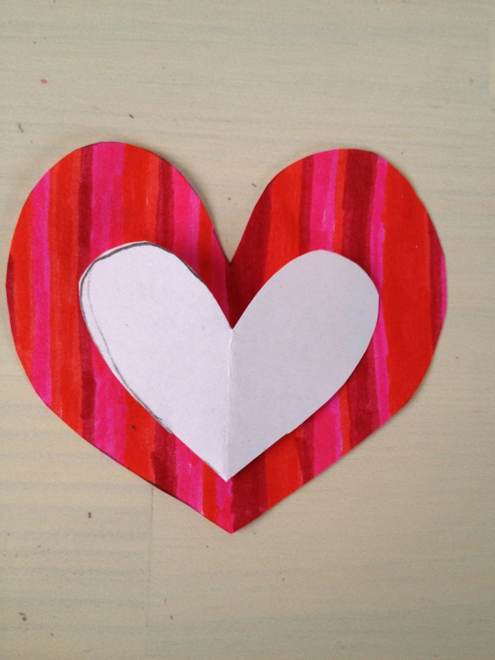 Draw a smaller heart that can go inside the bigger heart.