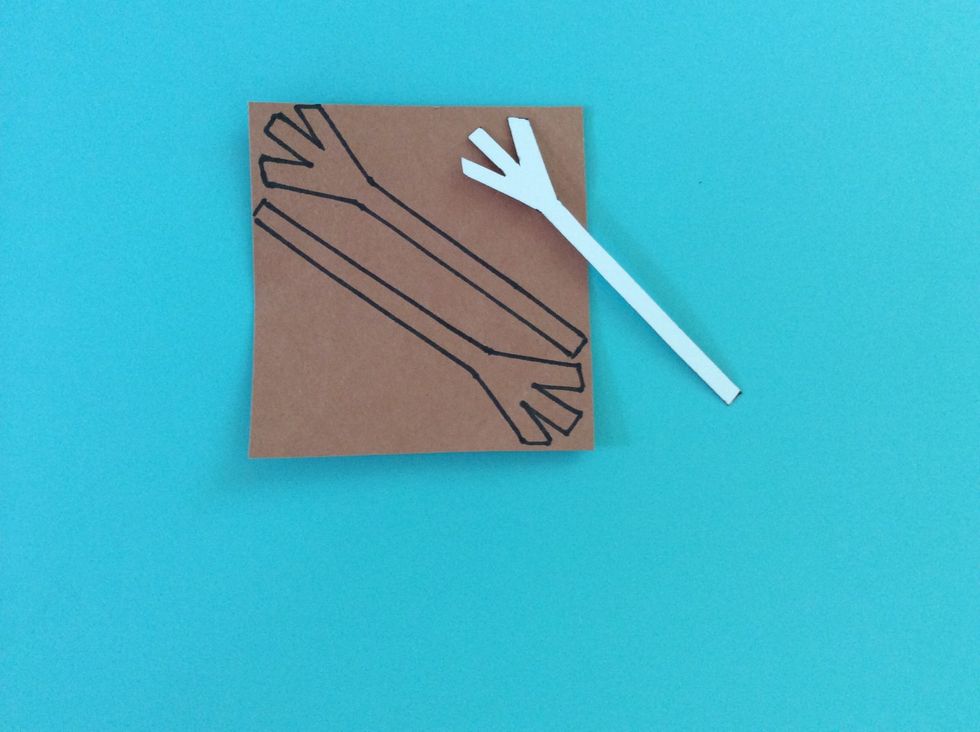 Draw a stick like arm on white poster board, and trace this two times on brown paper.