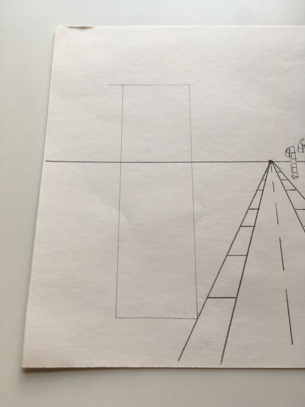 Draw a tall rectangle with the bottom corner touching the sidewalk.  Keep your lines straight.