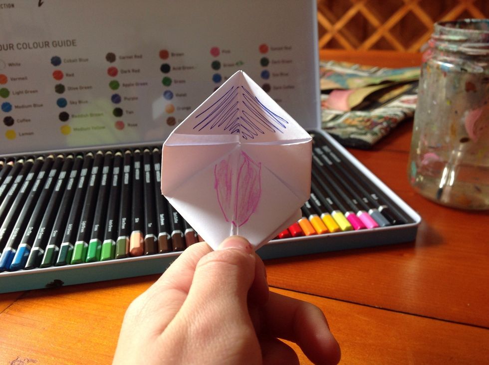 Draw a tongue with the pink pen. Now colour it in with the water pencils.