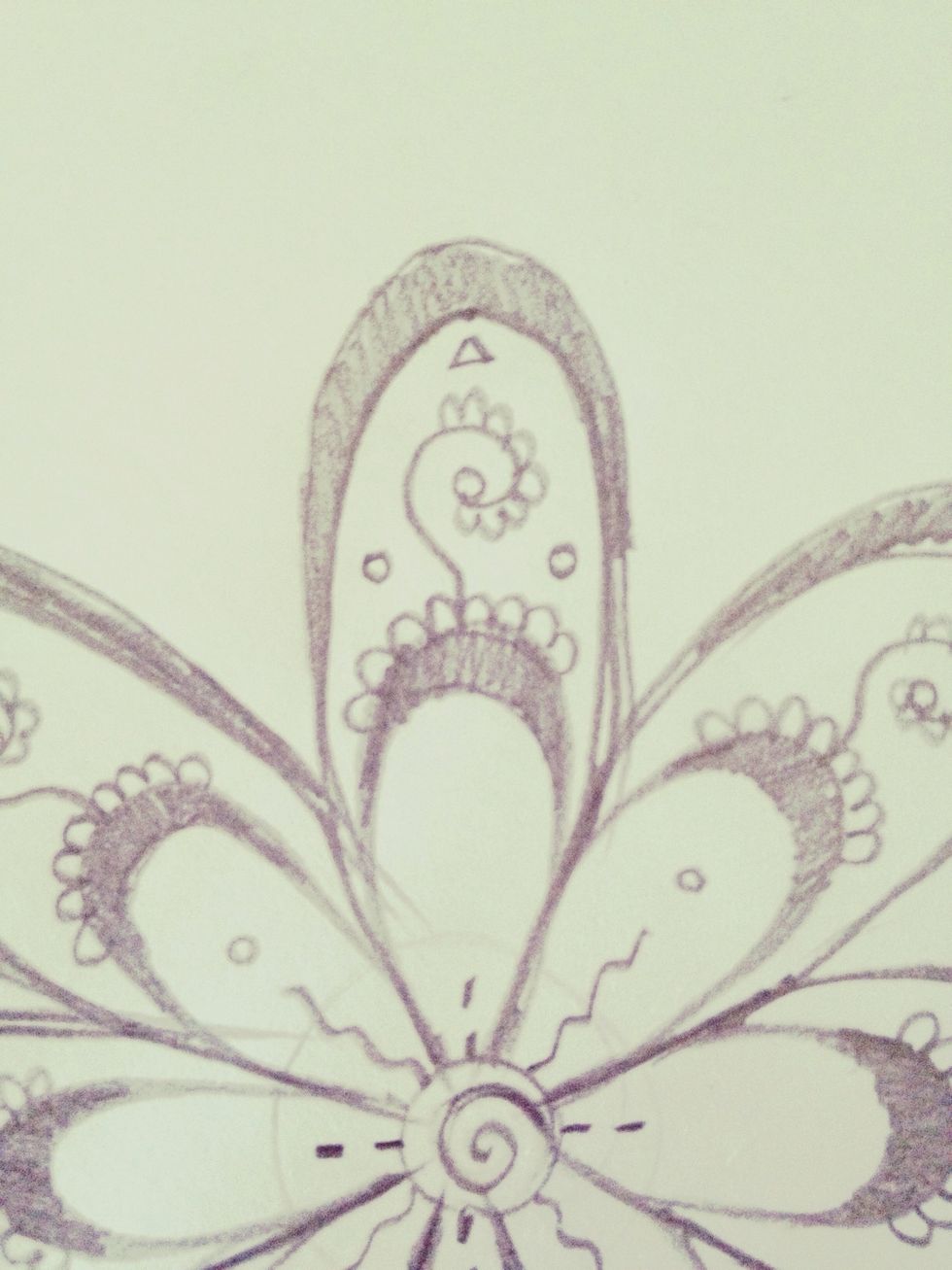 Draw a triangle (inside the petal) above the swirl and two circles next to the swirl, like this. Adding details just makes it look more complicated and eye-catching!
