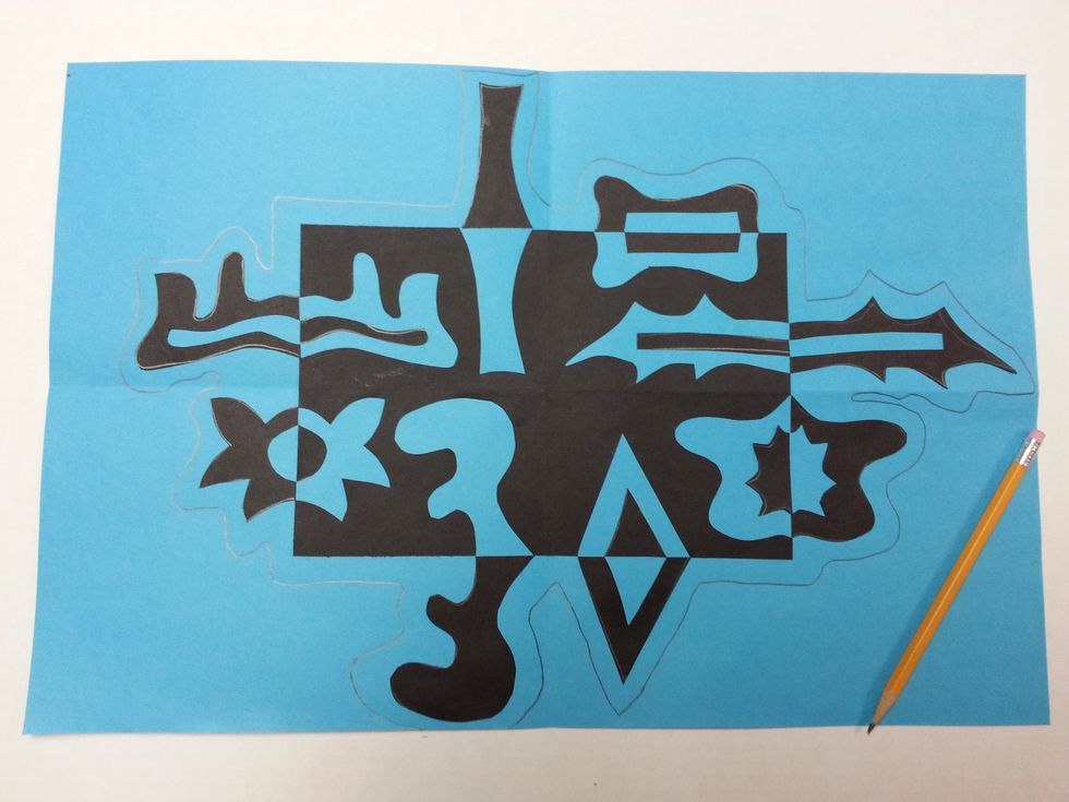 Draw an outline around your entire Notan design. (Make sure to leave a finger space of color showing around the outside of the shapes.) Cut on the line.