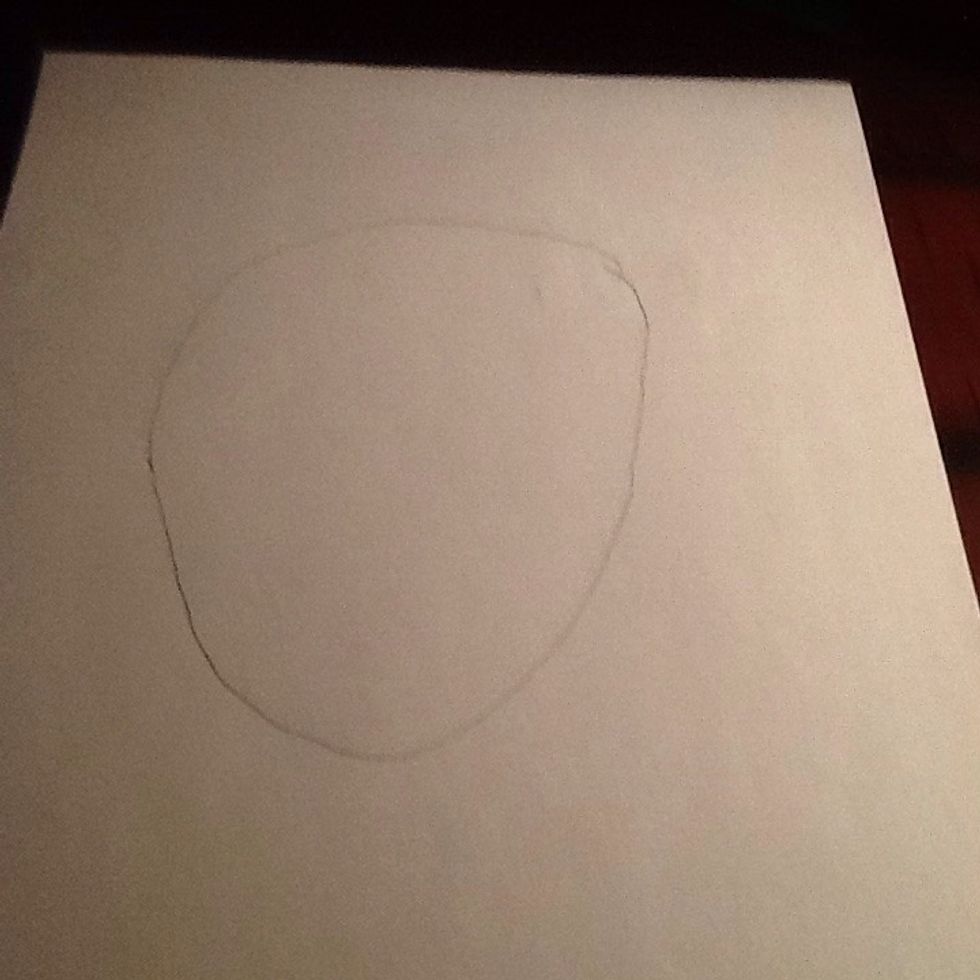 Draw an oval in the middle of the paper.