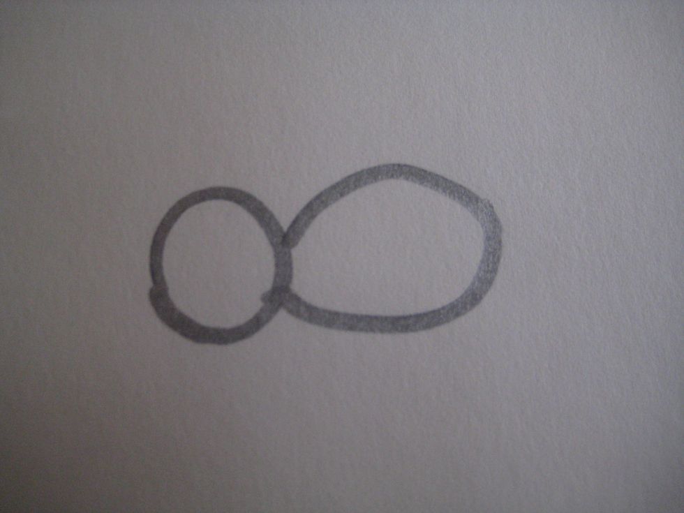 Draw an oval shape for the body that is touching the head.