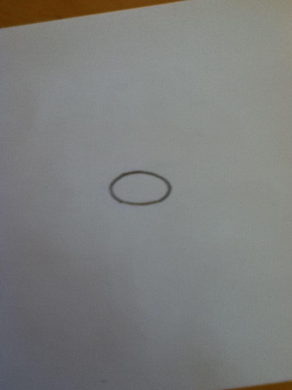Draw an oval. This will be your otter's nose.