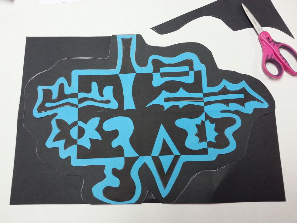 Draw another "bubble" around your new shape. (Make sure to leave at least a finger space of black paper showing all the way around.) Cut on the line.