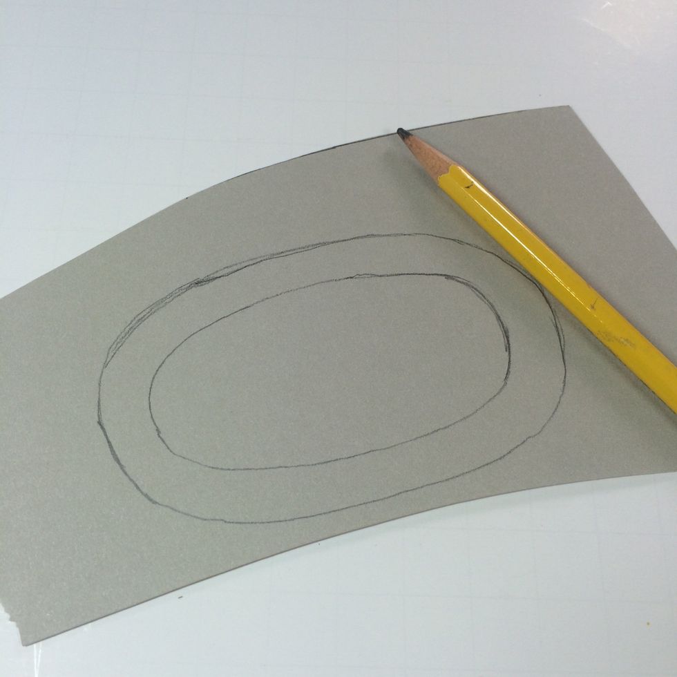 Draw another oval about 1/4 inch larger than your traced one. (Again, doesn't have to be perfect.)