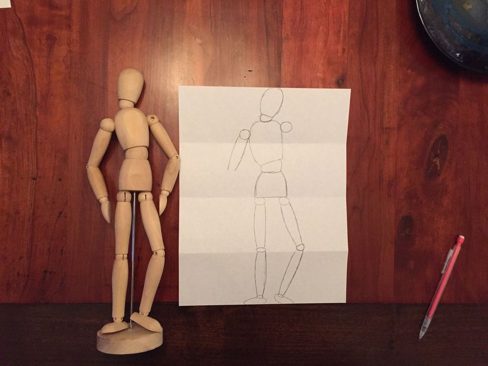Draw Bob's left upper arm. Bob's arm should come to the top of Bob's waist.