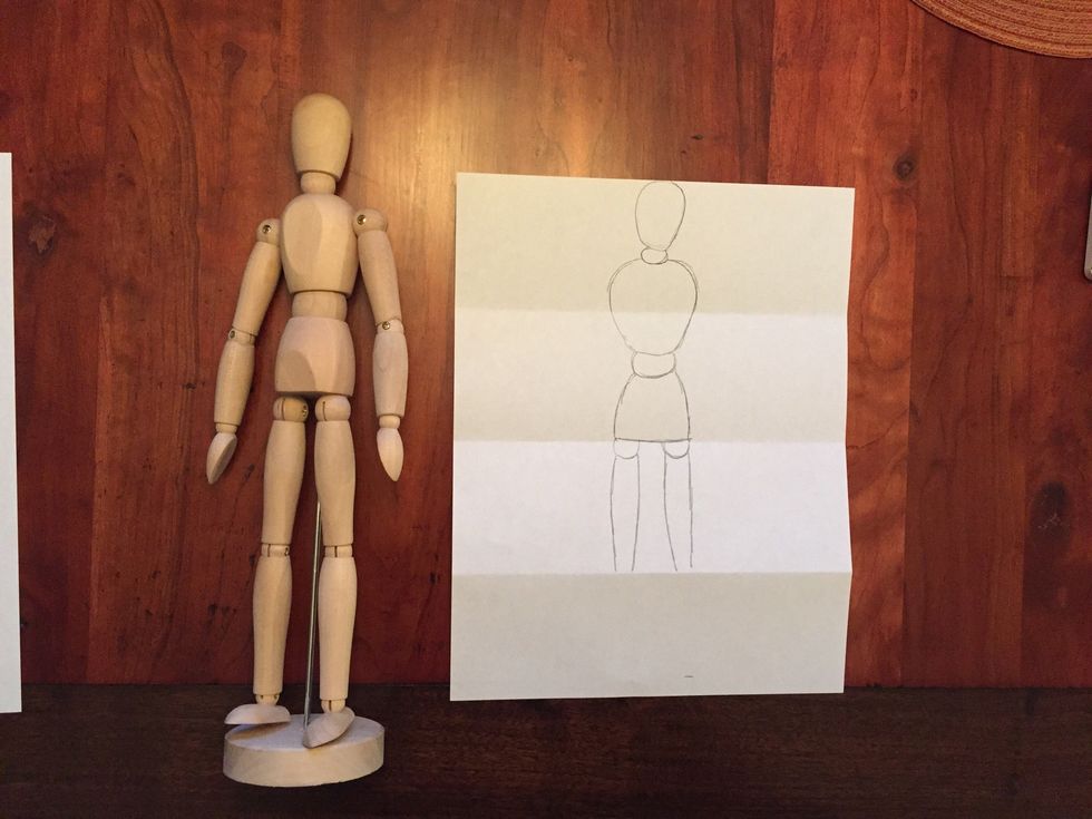 Draw Bob's thighs. Bob's thighs go to the bottom fold on your paper, filling the third section.