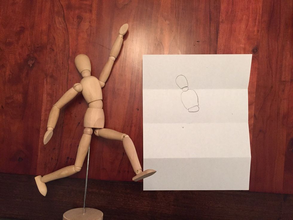 Draw Bob's waist. An oval. Notice how it's thinner on the left and thicker on the right. This helps Bob's back bend for his layup.