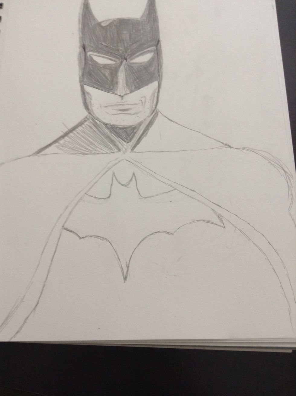 Draw his cape partially over the bat symbol