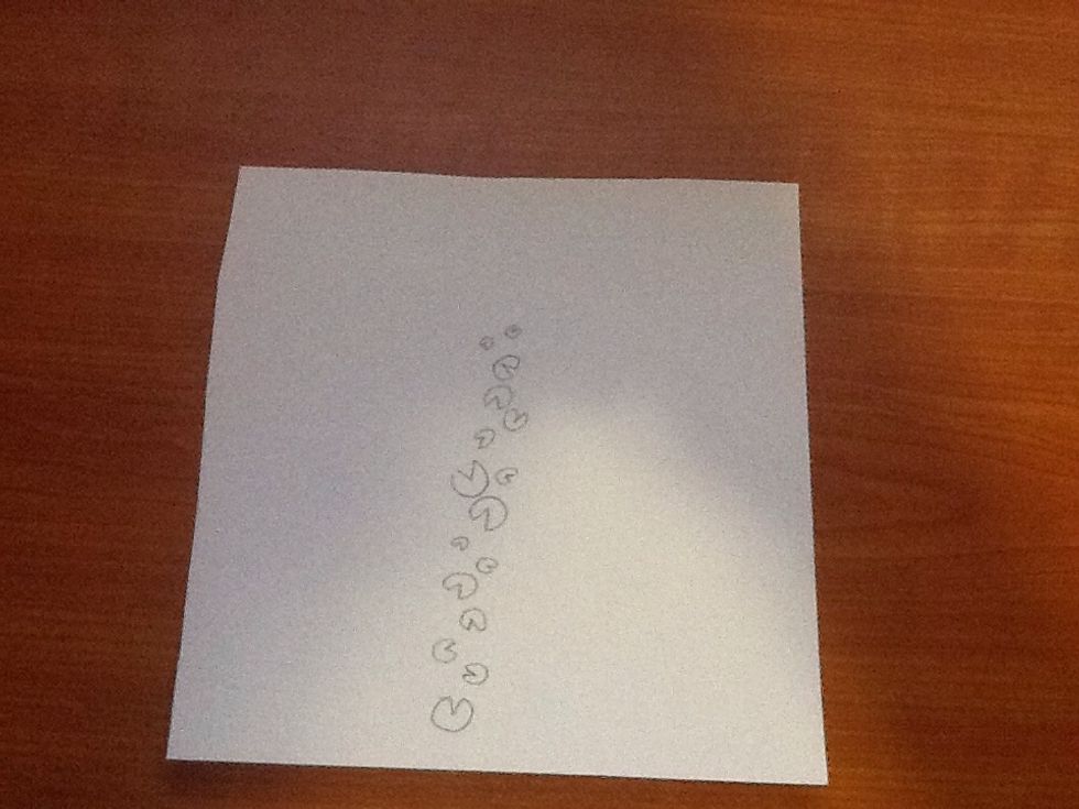 Draw lily pads from the bottom of the paper to a point where there is roughly 3 in. left. Do not draw in a strait line and make them different sizes