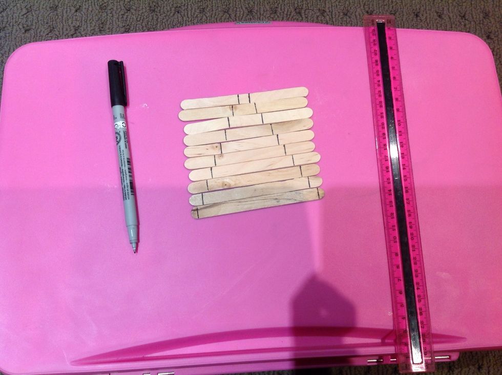 Draw markings where you are going to cut your pop sticks. This is up to you where you mark the measurements. We have done 1-10cm increasing by a cm each time. The more abstract the better!