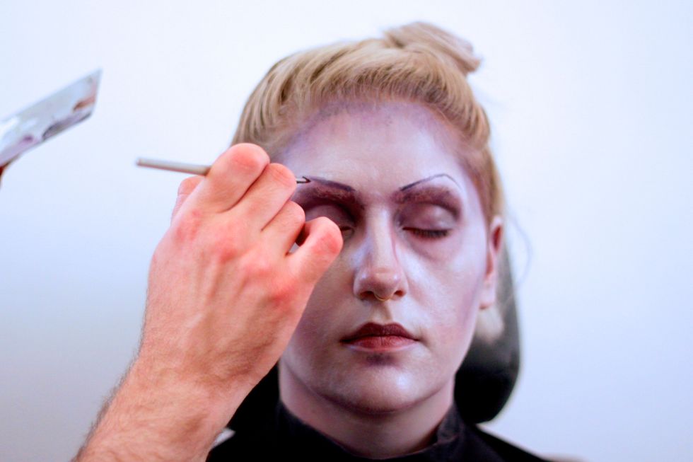 Draw on severe eyebrows with black.