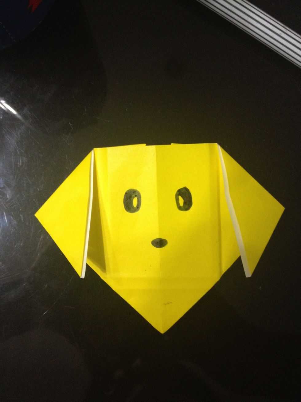 Draw on two eyes and a nose.