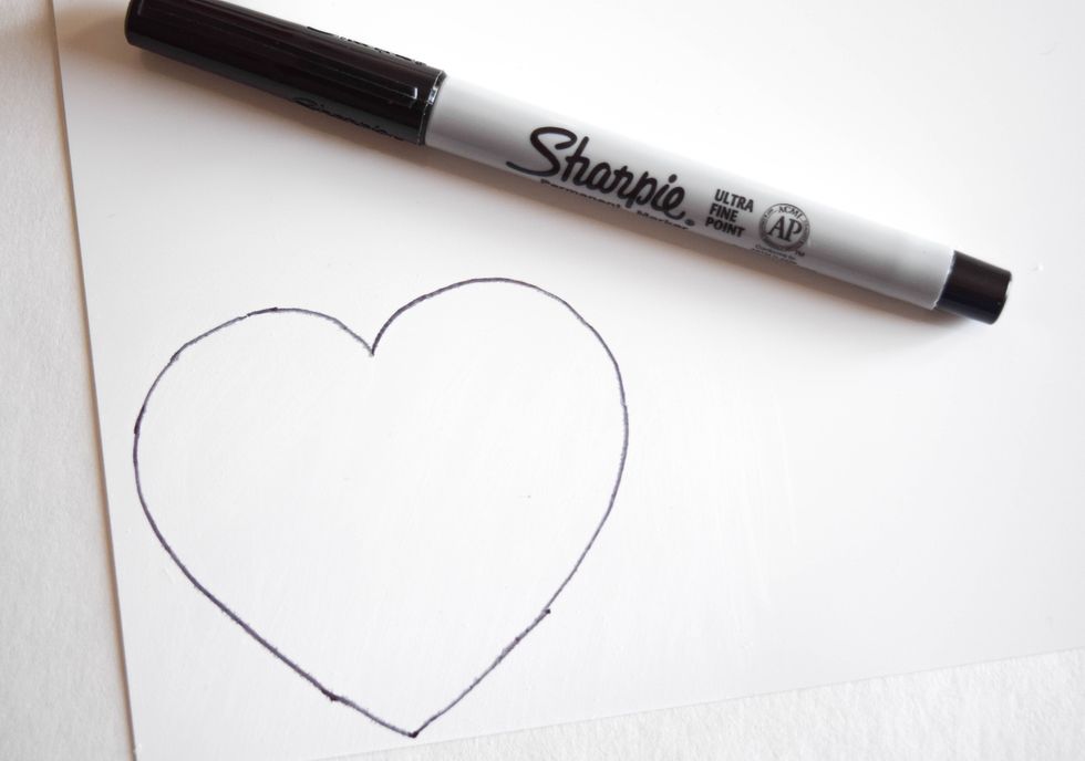 Draw or trace a heart on your sanded shrink plastic with a thin black Sharpie. Most shrink plastic will shrink up to 50% but make a practice piece to experiment with sizing.