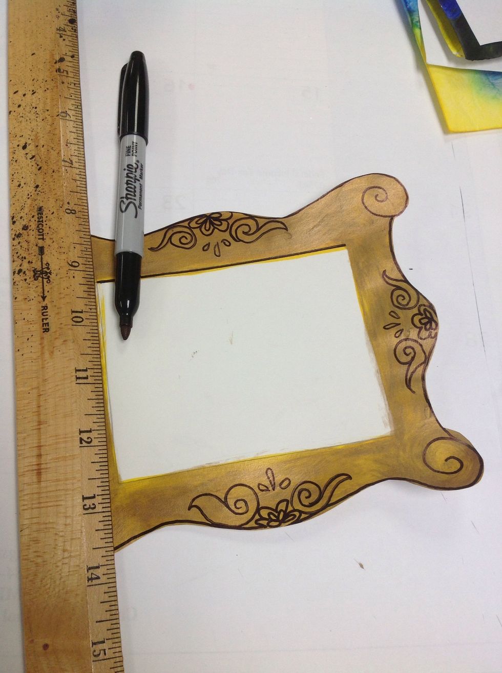 Draw ornate flowers and swirls. We looked at examples of frames and simplified. Symmetry!