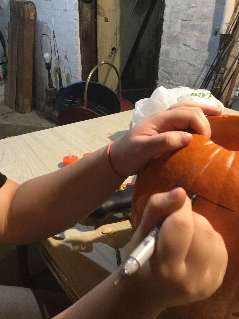 Draw out fall on the pumpkin with the sharpie.
