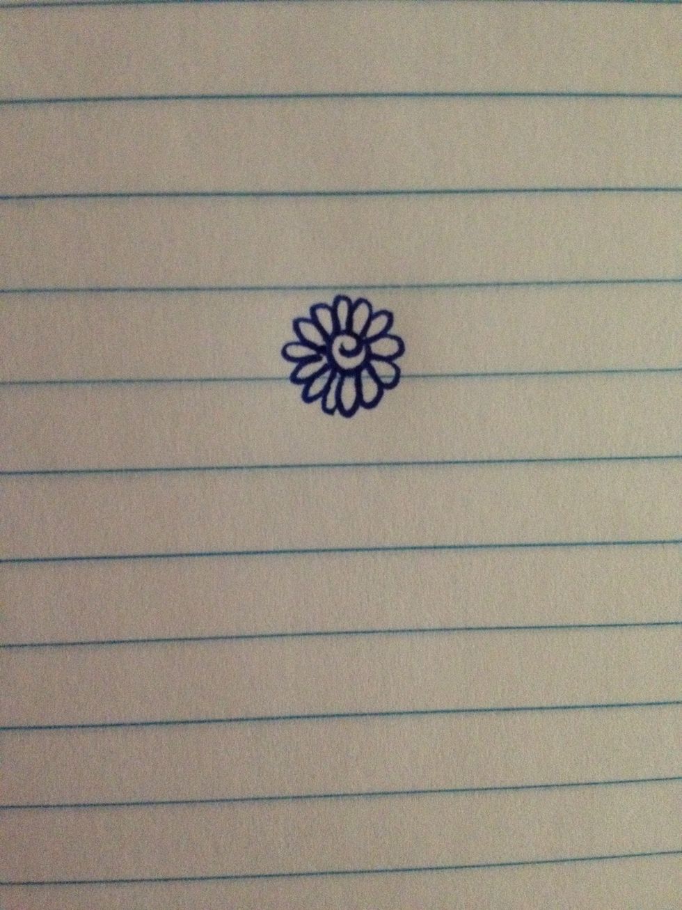 Draw small petals around the swirl. Keep your hand steady and relaxed.