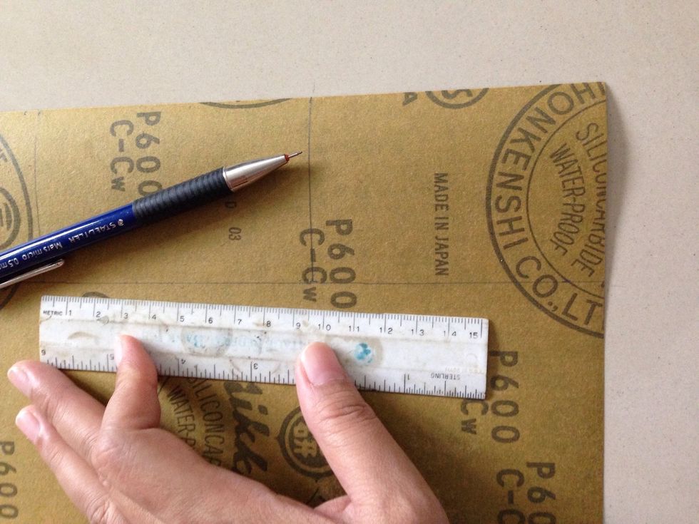 Draw the line in the back of sandpaper according your label size.