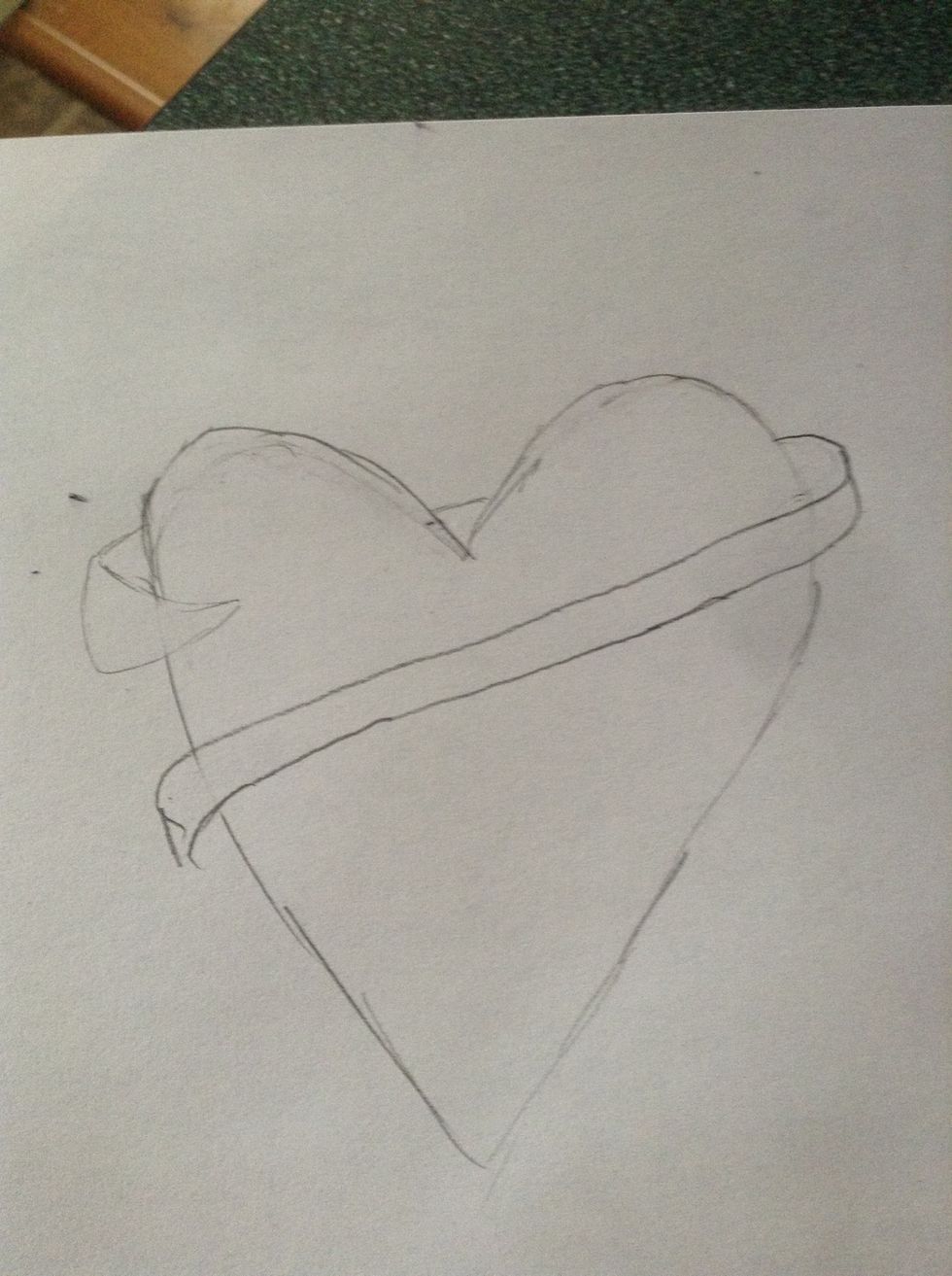 Draw the next part of the ribbon, and erase the inside lines of the heart